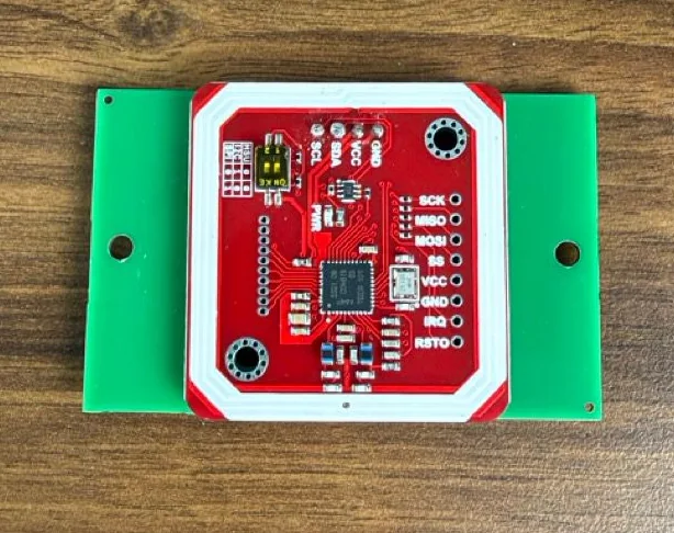 REV A custom green PCB with the red NFC reader and antenna module attached